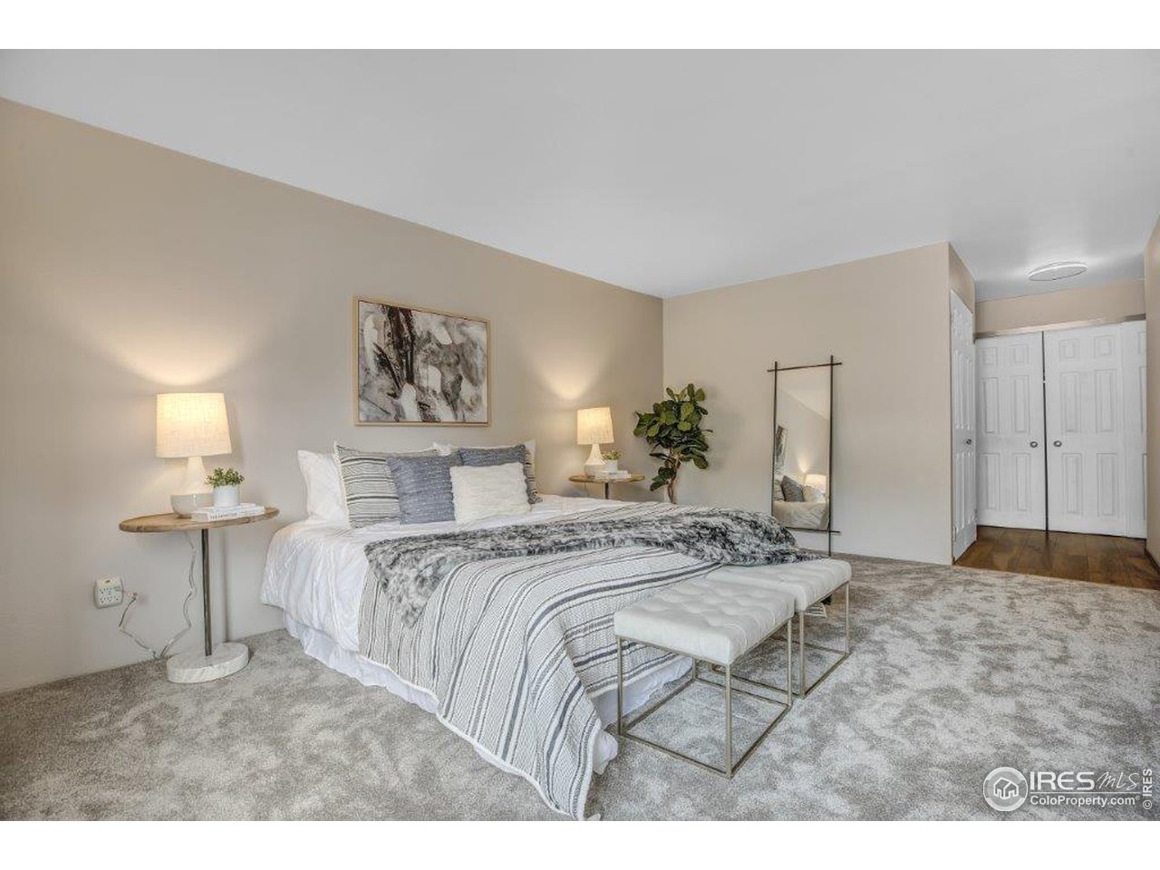 500 Mohawk Drive, Unit 103 Boulder, CO 80303 - Photo 13 of 28 a bed sitting in a spacious bedroom and a chandelier