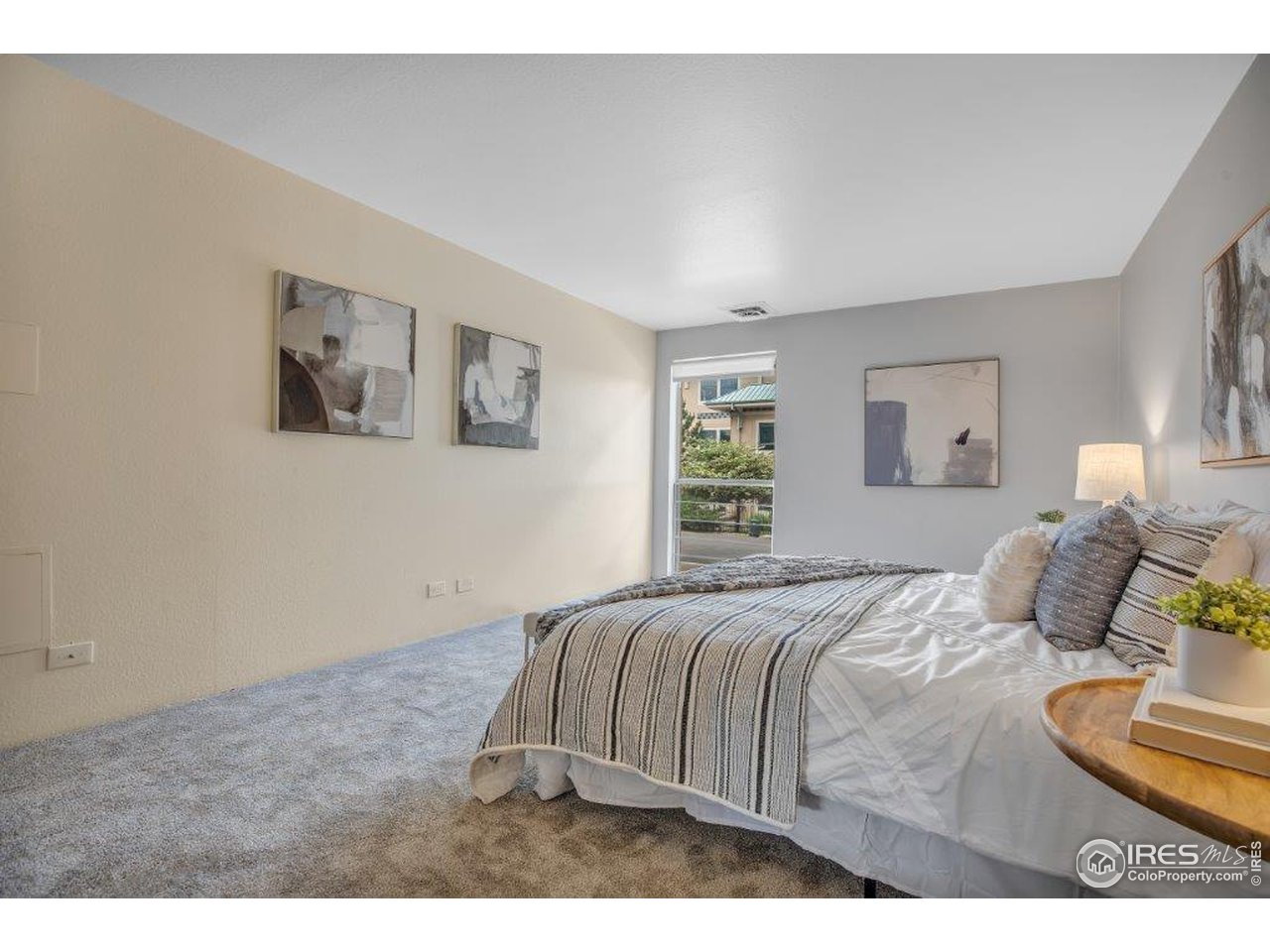 500 Mohawk Drive, Unit 103 Boulder, CO 80303 - Photo 14 of 28 a bedroom with a bed and wooden floor