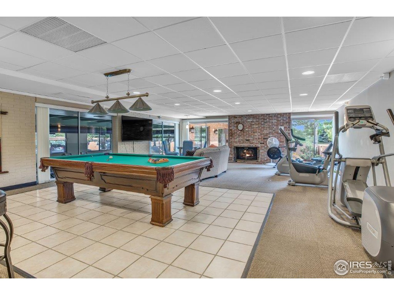 500 Mohawk Drive, Unit 103 Boulder, CO 80303 - Photo 22 of 28 a living room with furniture a pool table and a fireplace