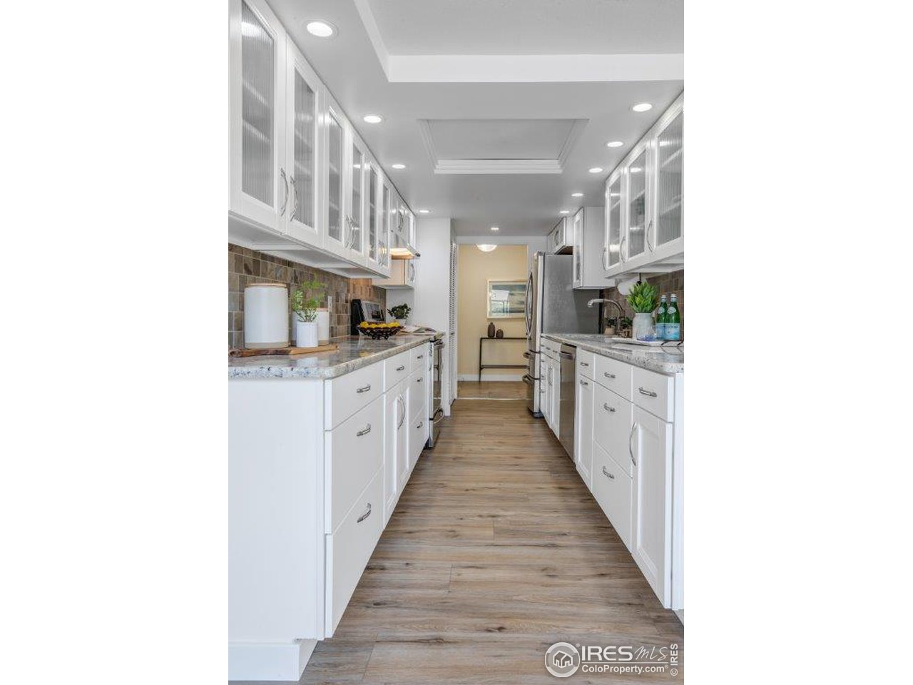 500 Mohawk Drive, Unit 103 Boulder, CO 80303 - Photo 7 of 28 a hallway with cabinets and a wooden floor