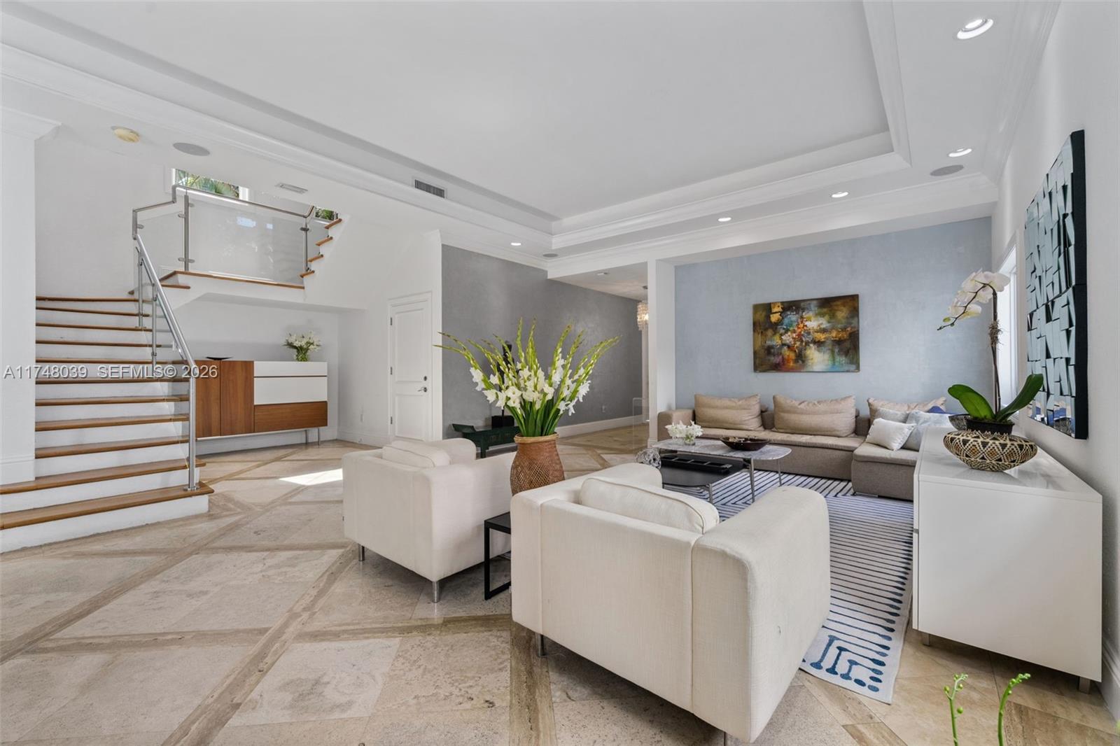 a living room with furniture and a potted plant