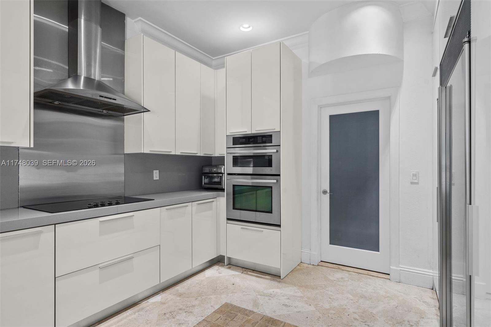 6 Coconut Lane Key Biscayne, FL 33149 - Photo 11 of 49 a kitchen with stainless steel appliances granite countertop a refrigerator and a stove top oven