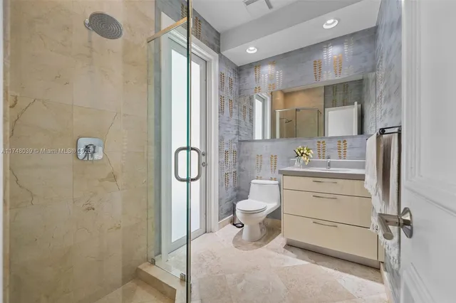 a bathroom with a granite countertop sink toilet and shower