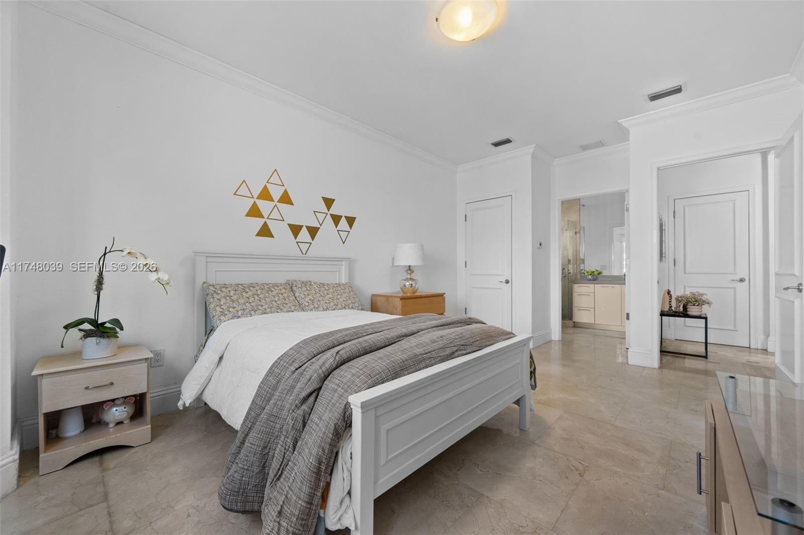 6 Coconut Lane Key Biscayne, FL 33149 - Photo 15 of 49 a bedroom with a bed and a chandelier