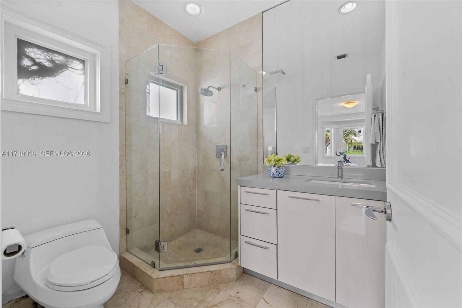 6 Coconut Lane Key Biscayne, FL 33149 - Photo 16 of 49 a bathroom with a granite countertop sink a toilet and shower