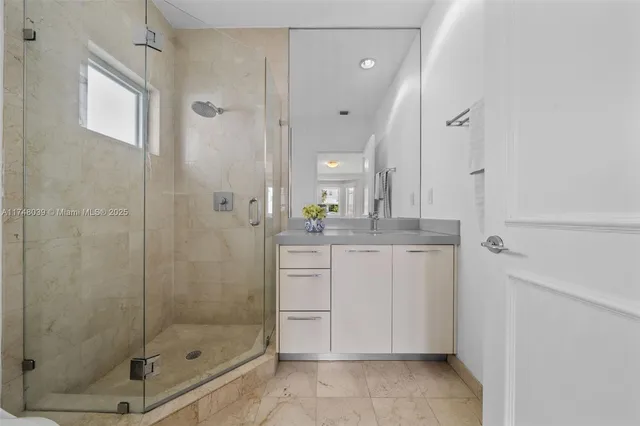 a bathroom with a shower and a sink