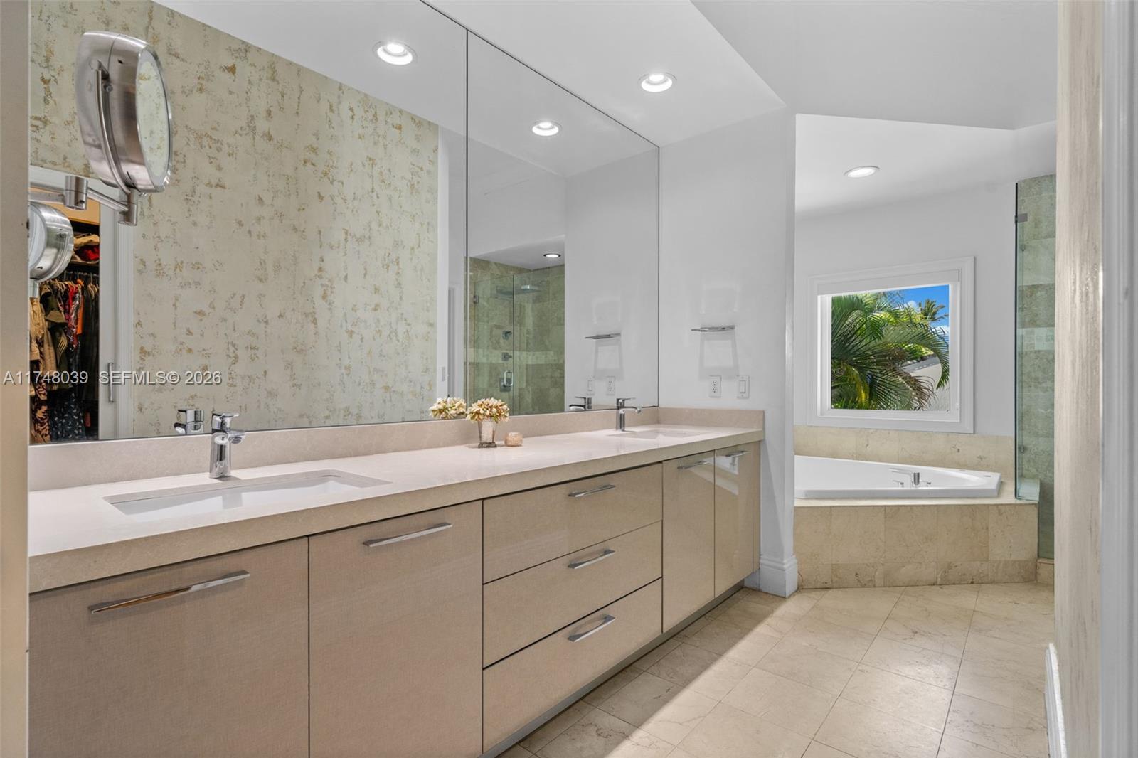 6 Coconut Lane Key Biscayne, FL 33149 - Photo 22 of 49 a bathroom with a tub a sink and mirror