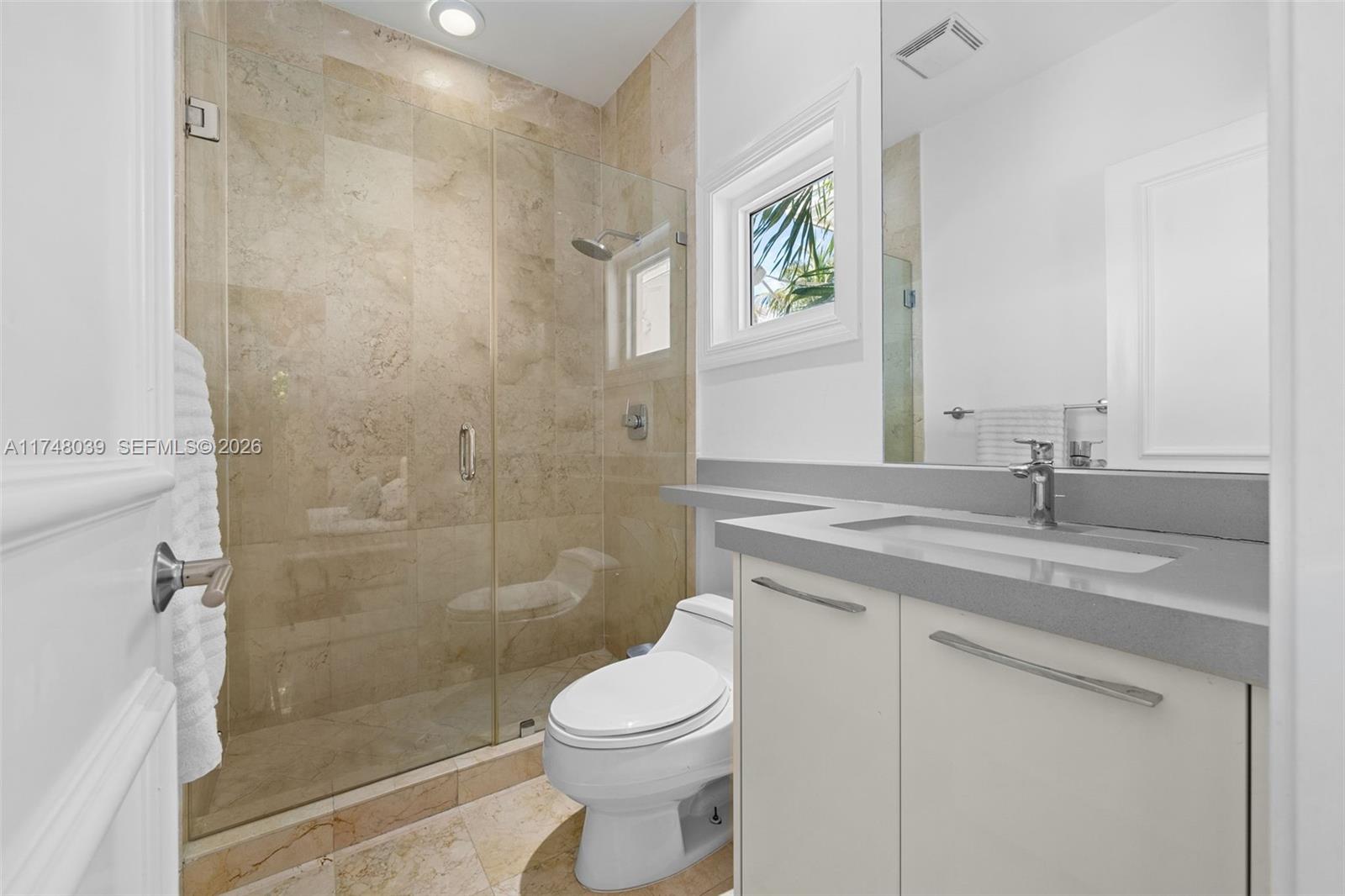 6 Coconut Lane Key Biscayne, FL 33149 - Photo 30 of 49 a bathroom with a granite countertop sink a toilet and shower