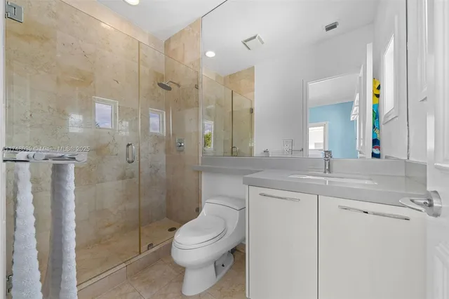 a bathroom with a double vanity sink toilet and shower
