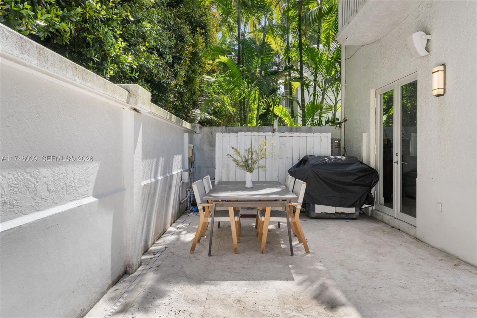6 Coconut Lane Key Biscayne, FL 33149 - Photo 40 of 49 a backyard of a house with outdoor seating