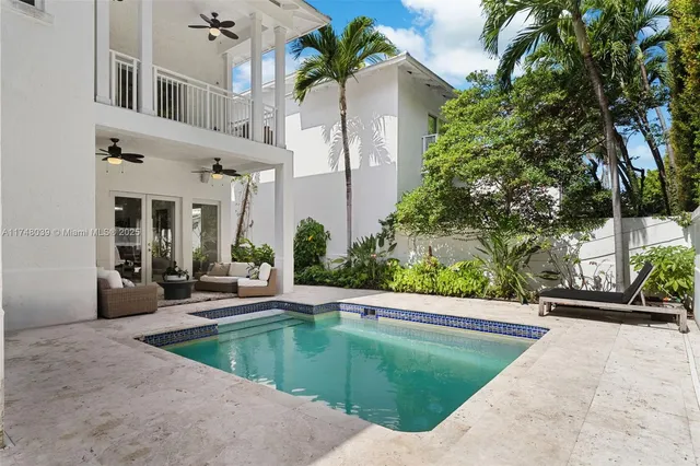 a view of a backyard with plants and swimming pool