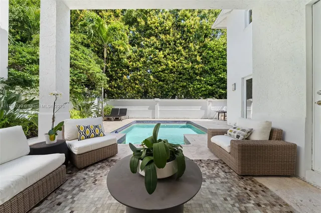 a living room with furniture and a potted plant