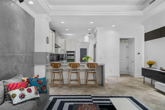 a living room with furniture and a dining table with kitchen view