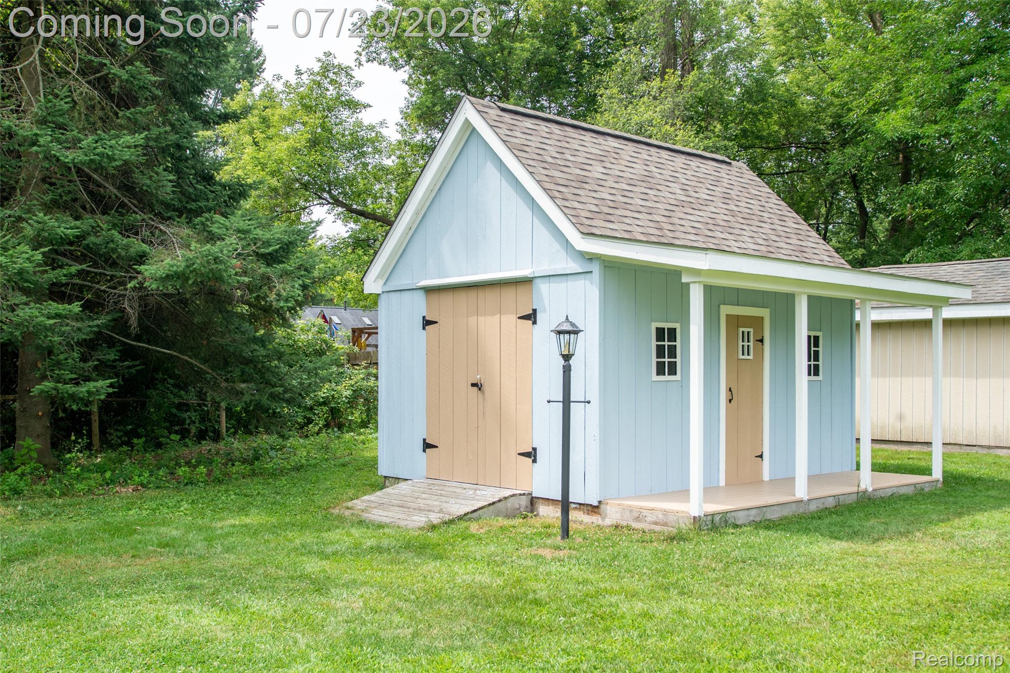 829 Francis Street Rochester, MI 48307 - Photo 25 of 25 Light blue shed with a gabled roof and shingle siding