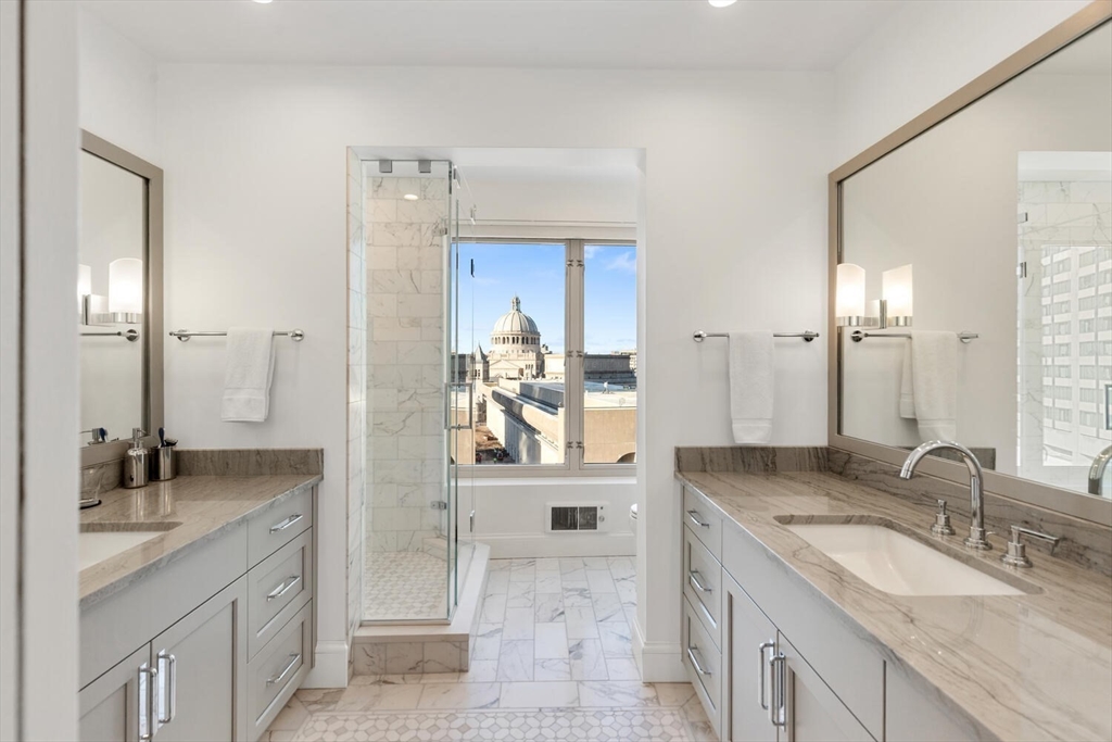 100 Belvidere Street, Unit 7A Boston, MA 02199 - Photo 23 of 40 a bathroom with a granite countertop sink and a mirror