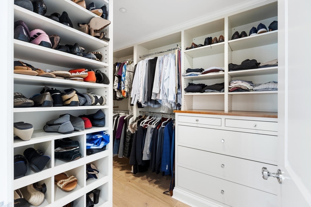 100 Belvidere Street, Unit 7A Boston, MA 02199 - Photo 25 of 40 a view of walk in closet with clothes and shoes