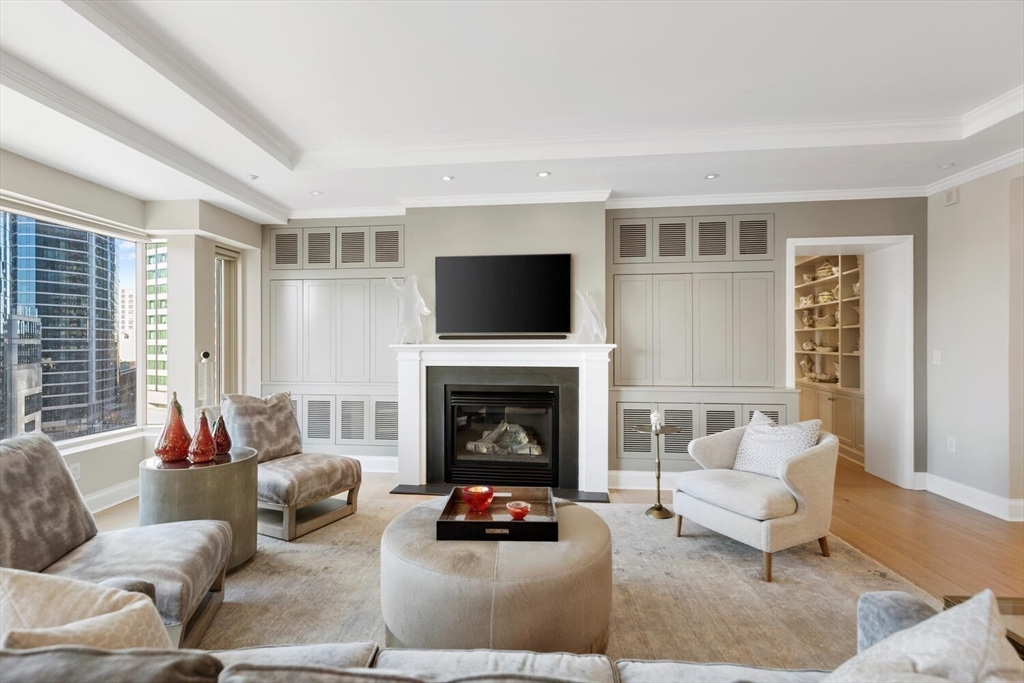 100 Belvidere Street, Unit 7A Boston, MA 02199 - Photo 5 of 40 a living room with furniture and a fireplace