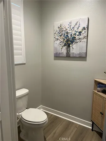 a white toilet sitting next to a bathroom sink