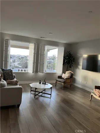 a living room with furniture and floor to ceiling window