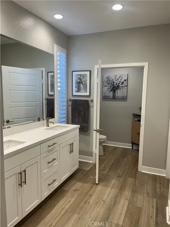 a bathroom with a double vanity sink and a mirror