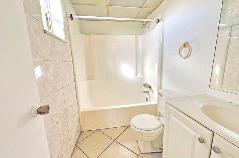 2800 Northwest 56th Avenue, Unit G407 Lauderhill, FL 33313 - Photo 5 of 15 a bathroom with a sink toilet and shower