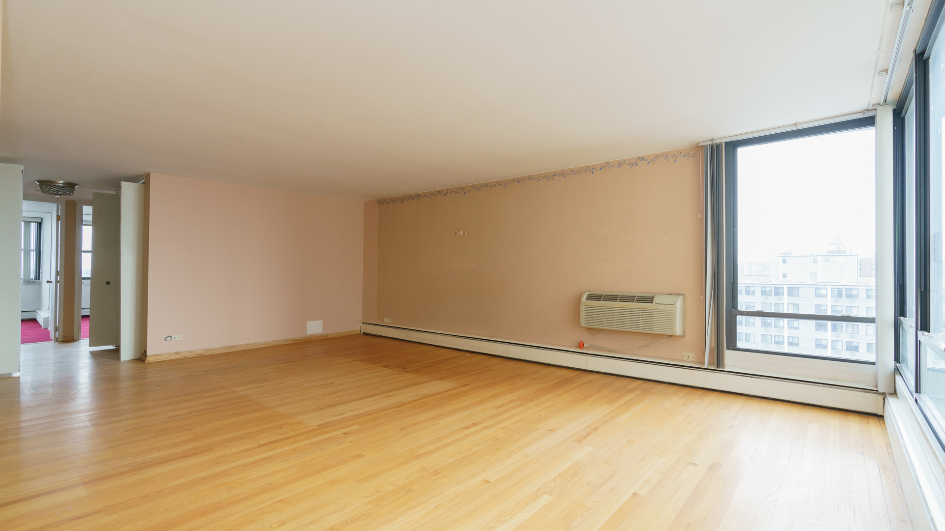 5740 North Sheridan Road, Unit 10D Chicago, IL 60660 - Photo 11 of 22 an empty room with wooden floor and windows