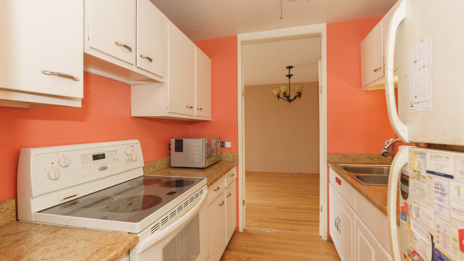 5740 North Sheridan Road, Unit 10D Chicago, IL 60660 - Photo 14 of 22 a kitchen with a refrigerator stove and white cabinets