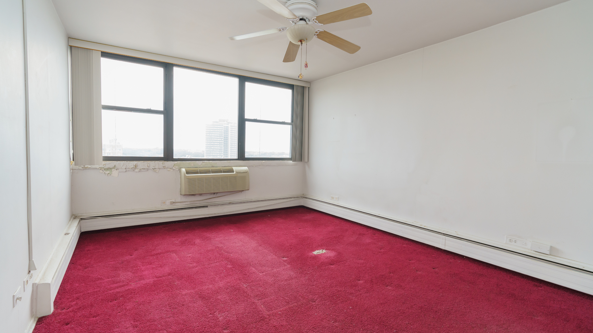 5740 North Sheridan Road, Unit 10D Chicago, IL 60660 - Photo 15 of 22 an empty room with a window and a ceiling fan