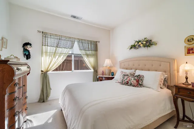 a bedroom with double bed and a window