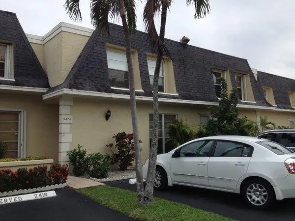 a view of a car park in front of house