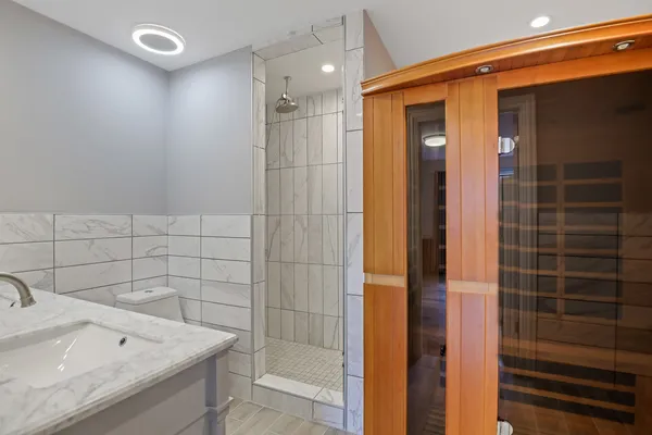 a bathroom with a shower and a sink