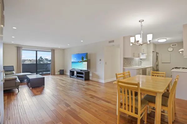 a view of a dining room with furniture window and wooden floor