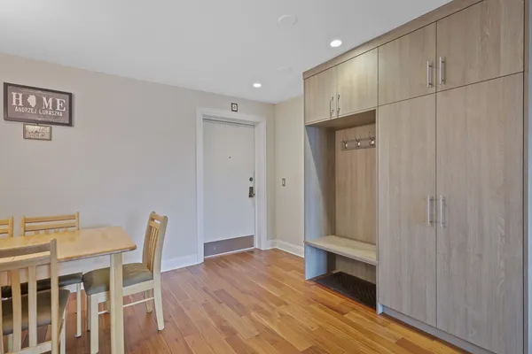 a view of an empty room with wooden floor