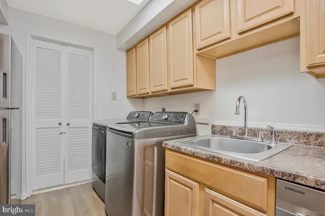 a kitchen with stainless steel appliances granite countertop white cabinets and a stove top oven