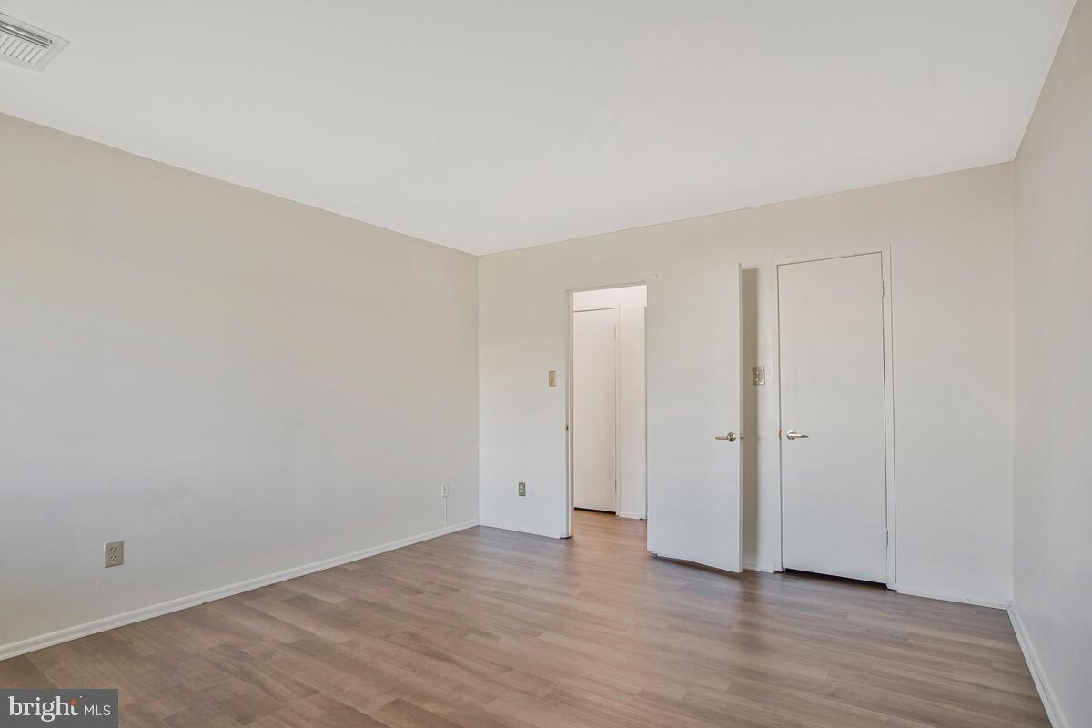 10216 Prince Place, Unit 9204 Upper Marlboro, MD 20774 - Photo 15 of 19 an empty room with wooden floor