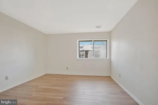 an empty room with wooden floor