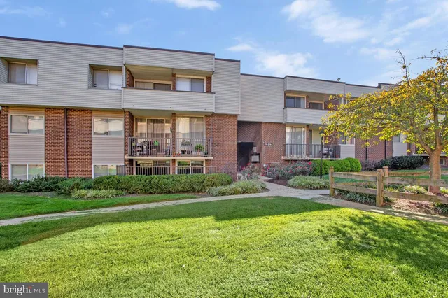 a front view of a building with a garden