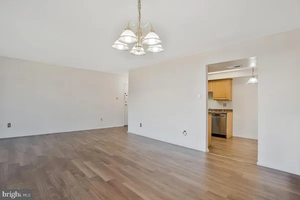 a view of an empty room with a kitchen