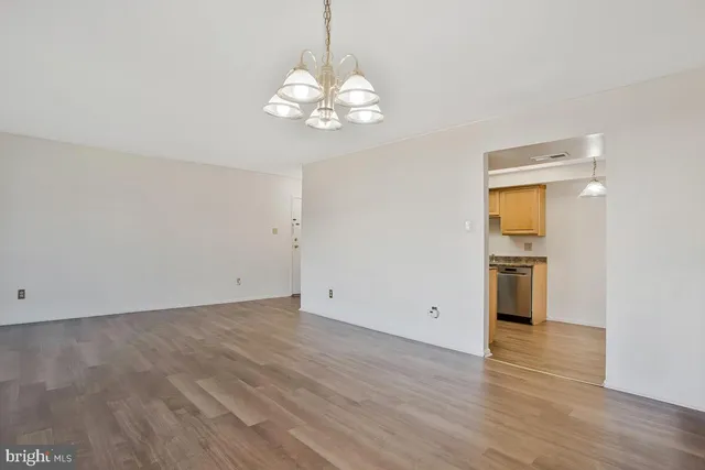 a view of an empty room with a kitchen