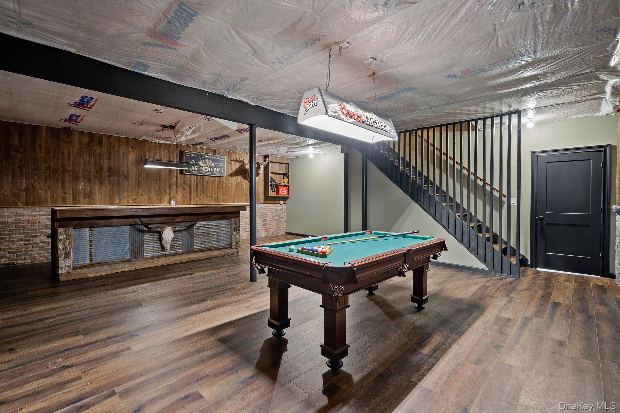 660 South Plank Road Newburgh, NY 12550 - Photo 30 of 50 a room with wooden floors stairs and a table