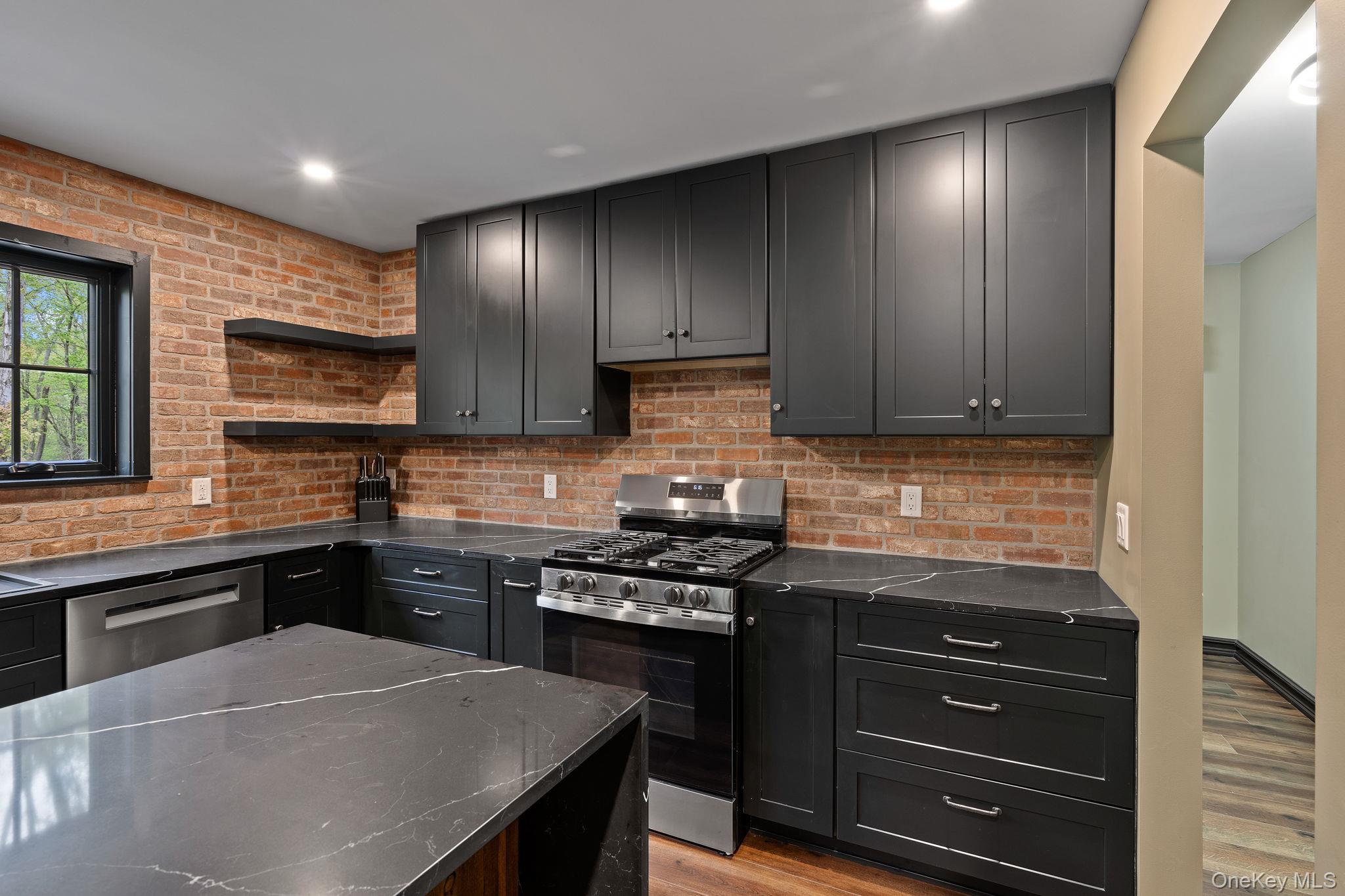 660 South Plank Road Newburgh, NY 12550 - Photo 7 of 50 a kitchen with a sink a stove and cabinets