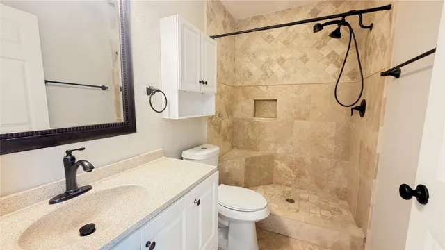 a bathroom with a sink toilet and shower
