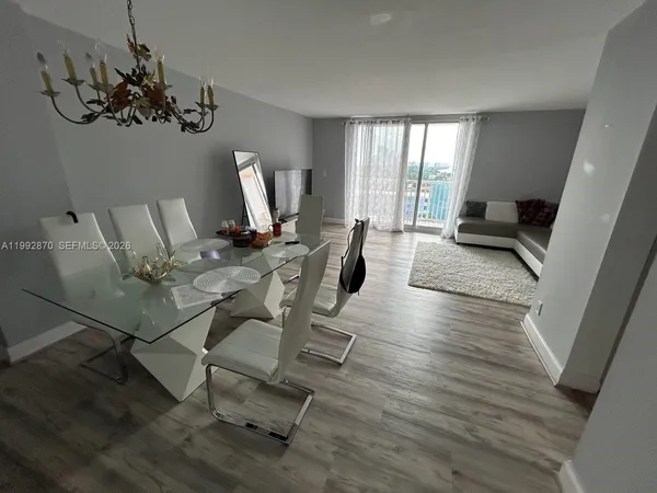 a view of a dining room with furniture window and wooden floor