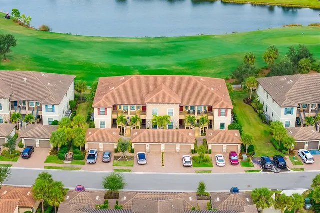 an aerial view of multiple houses with yard