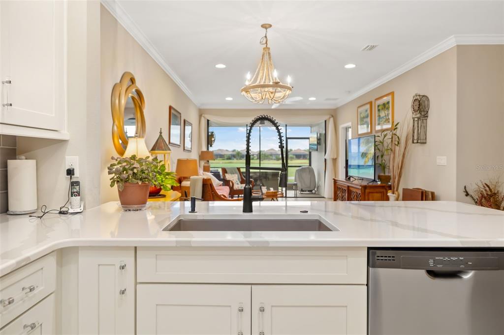 13725 Messina Loop, Unit 104 Bradenton, FL 34211 - Photo 11 of 77 a view of living room with granite countertop furniture a large window and potted plant