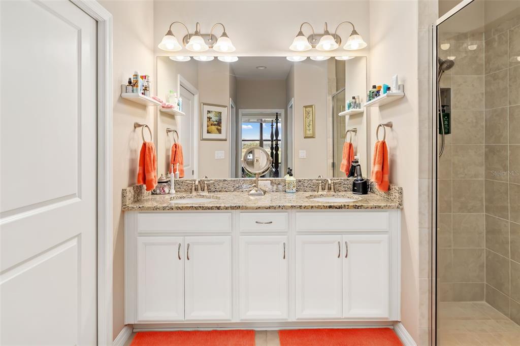 13725 Messina Loop, Unit 104 Bradenton, FL 34211 - Photo 17 of 77 a bathroom with a sink vanity and a mirror