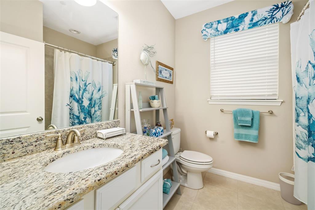 13725 Messina Loop, Unit 104 Bradenton, FL 34211 - Photo 21 of 77 a bathroom with a granite countertop sink toilet and shower