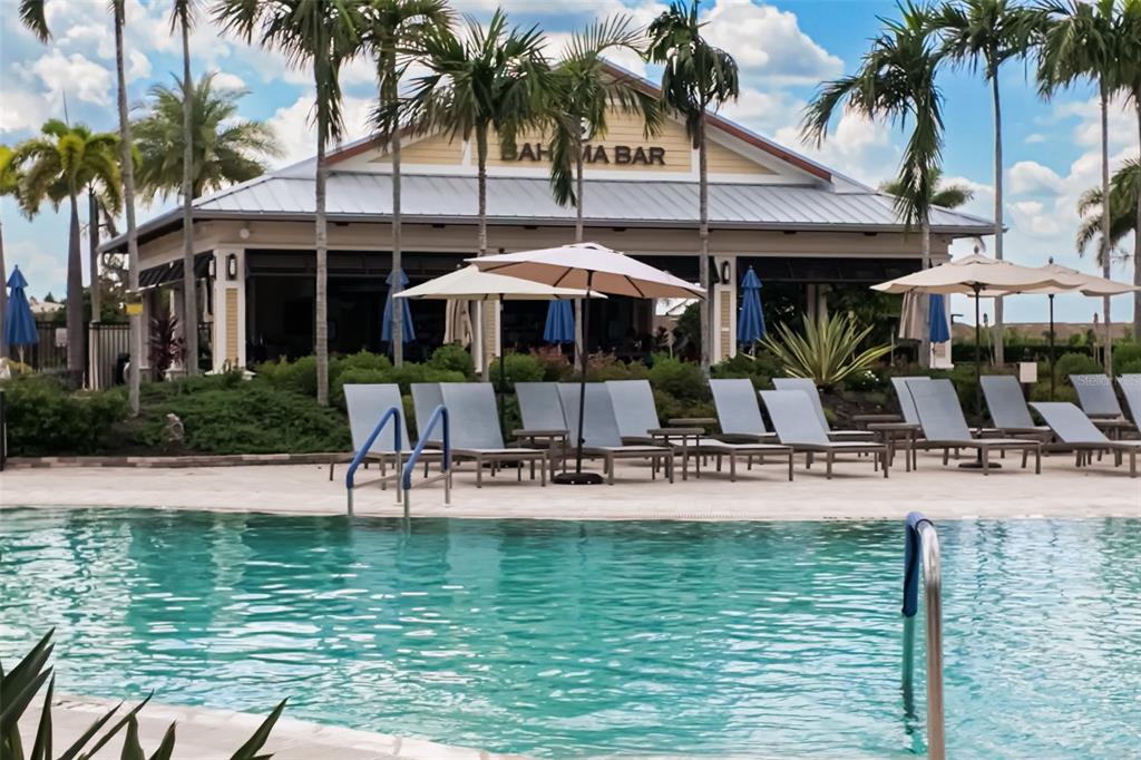 13725 Messina Loop, Unit 104 Bradenton, FL 34211 - Photo 54 of 77 a view of a swimming pool with a table and chairs