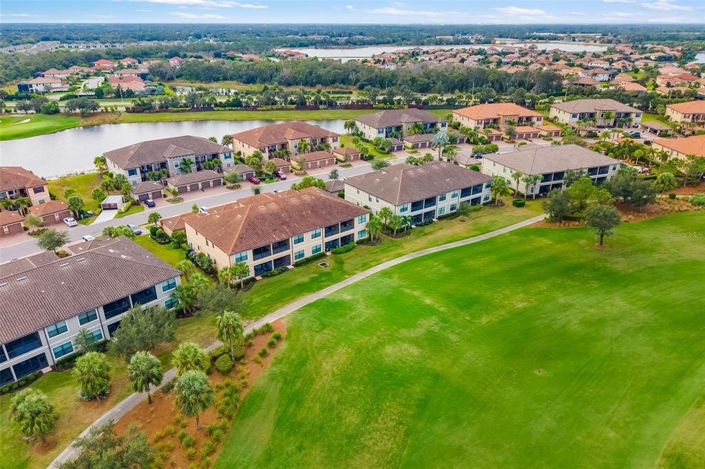 13725 Messina Loop, Unit 104 Bradenton, FL 34211 - Photo 69 of 77 an aerial view of a city with lake view