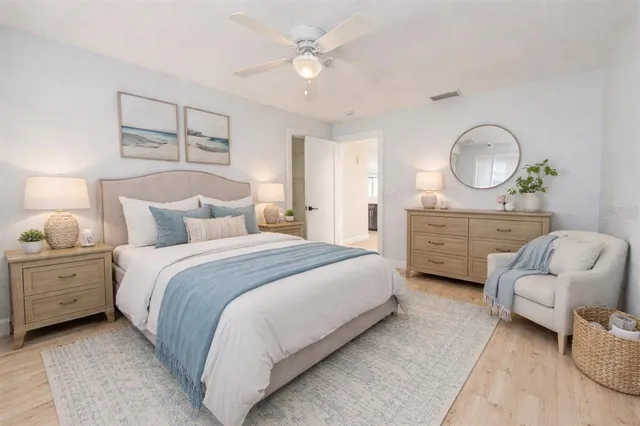 a bedroom with bed and a chandelier